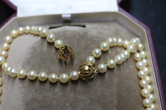 A Mikimoto pearl single strand long necklace with gold ball clasp (tests as 18ct) in Mikimoto box, 50 cm.